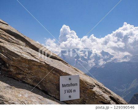 Mettelhorn, Switzerland - August 24th 2024: Arrival at the summit, the 2nd highest Swiss peak with a hiking trail Mettelhorn, Switzerland - August 24th 2024: Arrival at the summit, the 2nd highest Swiss peak with a hiking trail 129390546