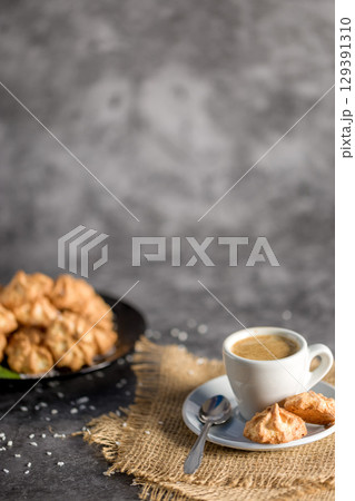 Homemade coconut cookies on a gray background. Healthy food concept. Copy space. For advertising confectionery products Homemade coconut cookies on a gray background. Healthy food concept. Copy space. For advertising confectionery products 129391310