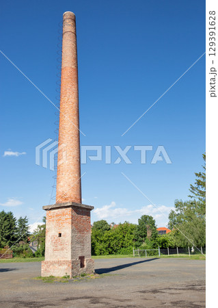 Historic brick chimney with metal ladder in Hungarian countryside. Historic brick chimney with metal ladder in Hungarian countryside. 129391628