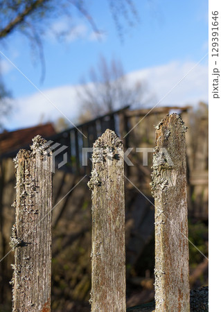 Weathered Fence Posts Standing Strong Against a Beautifully Clear Sky During Daylight 129391646