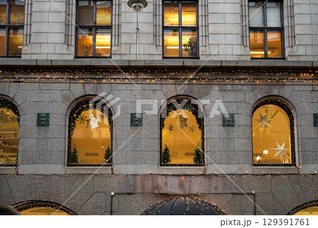 Facade of building decorated with Christmas lights and stars in Helsinki 129391761