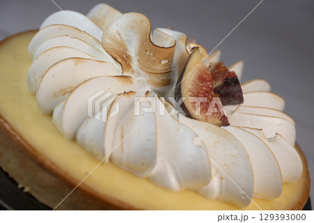 Sunny and Bright Orange Lemon Citrus Meringue Pie on a black plate on white background Sunny and Bright Orange Lemon Citrus Meringue Pie on a black plate on white background 129393000