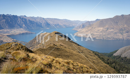 Beautiful alpine autumnal landscape with mountain ridges and lake nested between them, New Zealand 129393787