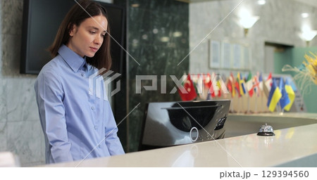 Portrait of professional woman manager of hotel at reception. Concierge service, woman smile in lobby for check in assistance, reservation and help. 129394560