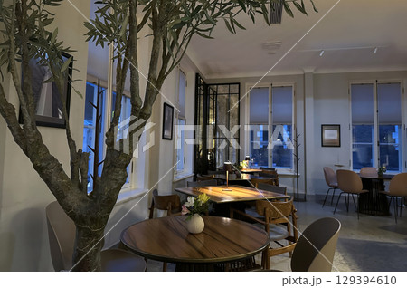 An intimate interior shot of a stylish, modern cafe or restaurant with a minimalist aesthetic.  129394610