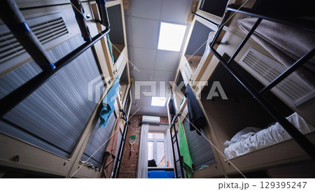 Compact hostel beds providing privacy and comfort for travelers 129395247
