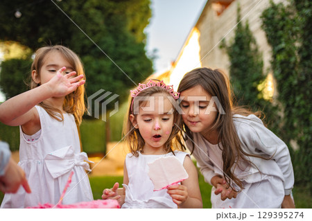 Three joyful girls celebrate a sunny day outdoors Three joyful girls celebrate a sunny day outdoors 129395274