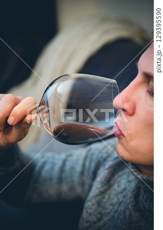 man drinking wine and relaxing 129395590