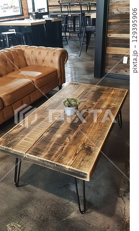 A wooden coffee table with a potted plant on top of it 129395906