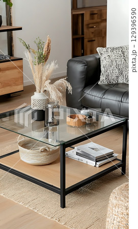Glass coffee table with a basket on top of it 129396590