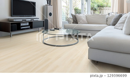 Living room with a white couch and a glass coffee table 129396699