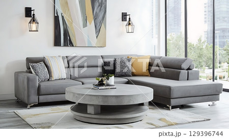 Gray sectional sofa is surrounded by a coffee table and a yellow pillow 129396744