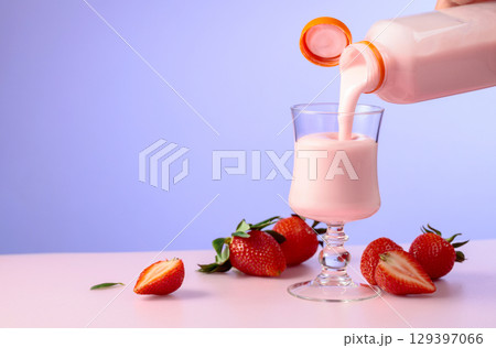 Strawberry milkshake smoothie and fresh berries on a colorful background. 129397066