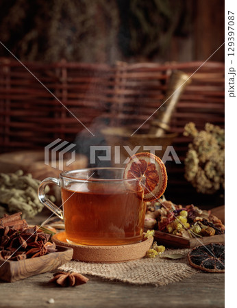 Tea with ingredients and slices of dried oranges. 129397087