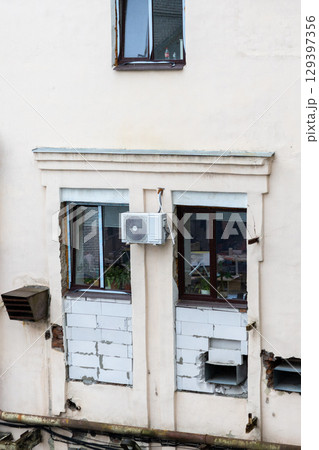 Air conditioners are installed on facade of building. device for comfortable living in hot weather. 129397356