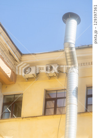 Air conditioners are installed on facade of building. device for comfortable living in hot weather. 129397361