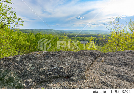 Valley view from the top of rock formation in the forested area. 129398206