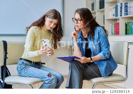 Teenage student girl at therapy session with mental health counselor Teenage student girl at therapy session with mental health counselor 129398314