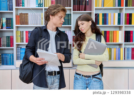 Portrait of two teenage students classmates boy and girl talking at school Portrait of two teenage students classmates boy and girl talking at school 129398338