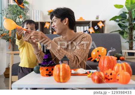 Halloween Celebration. Father and son enjoying festive activities together. 129398433
