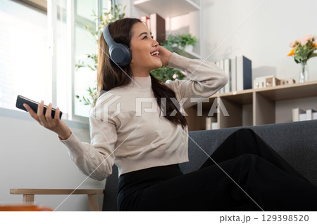 Relaxing Music Moment. Woman enjoying music with headphones at home. Relaxing Music Moment. Woman enjoying music with headphones at home. 129398520