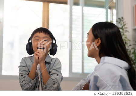 Joyful Child Singing with Headphones at Home 129398622