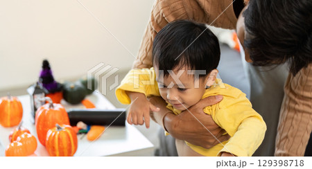 Father and Child. Tender moment of a dad lifting his son during festive activities. Father and Child. Tender moment of a dad lifting his son during festive activities. 129398718