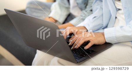 Mother and son collaborating on laptop for educational tasks at home. Mother and son collaborating on laptop for educational tasks at home. 129398729