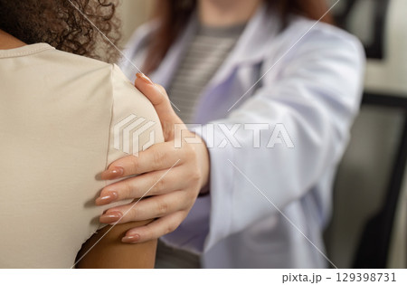 Patient Support. Doctor providing comfort during medical examination. Patient Support. Doctor providing comfort during medical examination. 129398731