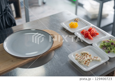 The chef lays out the salad. The chef lays out the salad. 129400723