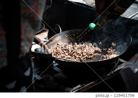 Rice topped with stir-fried pork or beef and basil 129401706