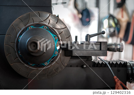 Checking car brake system for repair at car garage Checking car brake system for repair at car garage 129402316