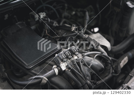 Car mechanic drain the old lubricant engine oil 129402330