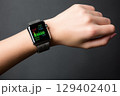 Close-Up of a Modern Smartwatch Displaying Fitness Statistics on a Wrist Against a Dark Background 129402401