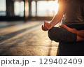 Peaceful Morning Yoga Practice by Window in Soft Sunlight in Indoor Space 129402409