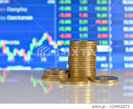 AI generated stack of shiny dollar coins on reflective glass table with modern trading floor backdrop featuring stock market boards and financial data displays 129402875