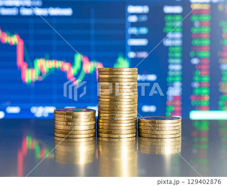 AI generated stack of shiny dollar coins on reflective glass table with modern trading floor backdrop featuring stock market boards and financial data displays 129402876