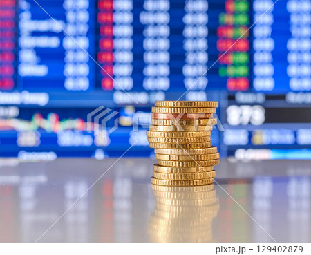 AI generated stack of euro coins on reflective glass surface with modern European trading floor backdrop showing stock market boards and financial monitors 129402879