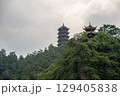 Traditional Pagoda Towers Surrounded by Lush Greenery on a Cliff 129405838
