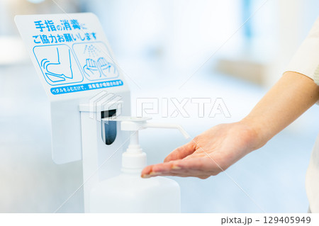 消毒する女性の手元 129405949