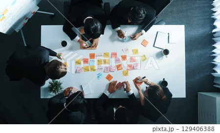 Top view of business people writing marketing idea on sticky note. Directorate. Top view of business people writing marketing idea on sticky note. Directorate. 129406388