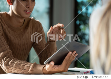 Modern UX UI Designer Working on Tablet in Bright Office Environment for Innovative Digital Solutions 129406632
