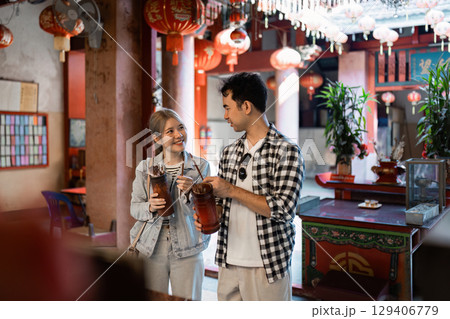 Travel adventure exploring a vibrant asian tea house local culture casual dining indoor setting engaging experience 129406779