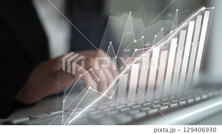 Person Typing on Keyboard with Graph Overlay Showing Growth in Financial Data, Business Performance, and Investment Trends in Modern Office Environment Copula 129406930