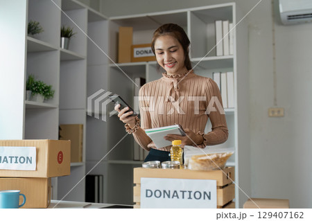 Volunteers Organizing Donations at Food Banks and Community Centers for Charitable Support and Assistance 129407162