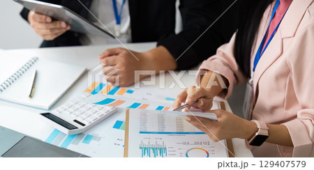 Data Analysis. Professionals reviewing financial documents and charts in a collaborative workspace. 129407579