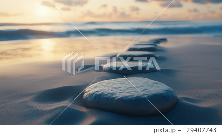 Stepping grey stones with texture forwarding in beach sand and ocean water with blue sky 129407743