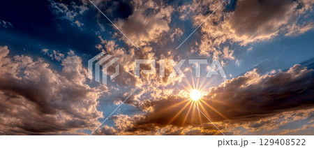 Dramatic sky filled with clouds and sun. 129408522