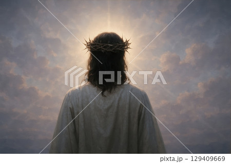 Jesus christ with a crown of thorns, seen from behind, looking towards a bright sky 129409669