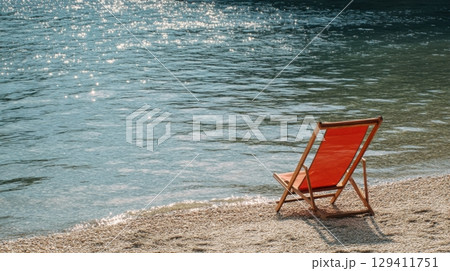 serene beach scene with empty red deck chair 129411751